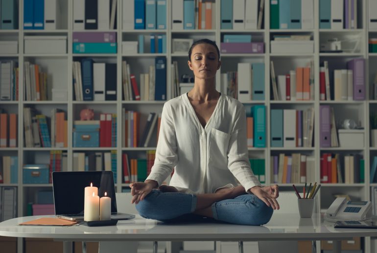 Woman practicing meditation at home